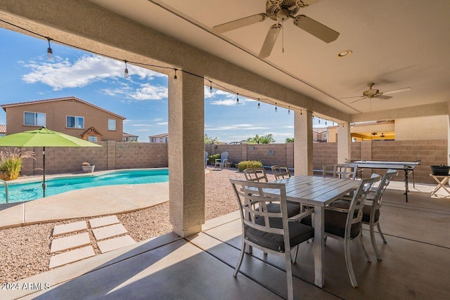 view of patio with ceiling fan and a fenced in pool