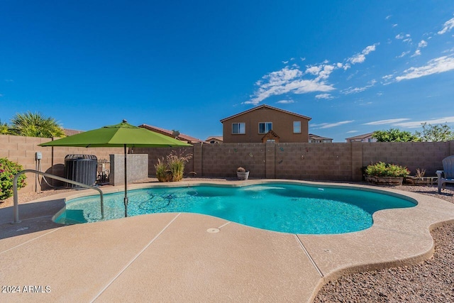 view of swimming pool featuring cooling unit and a patio