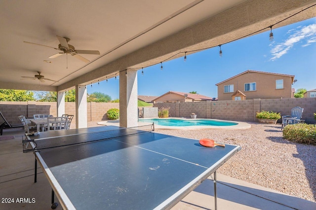 view of patio featuring a fenced in pool and ceiling fan