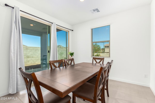 tiled dining space with a wealth of natural light