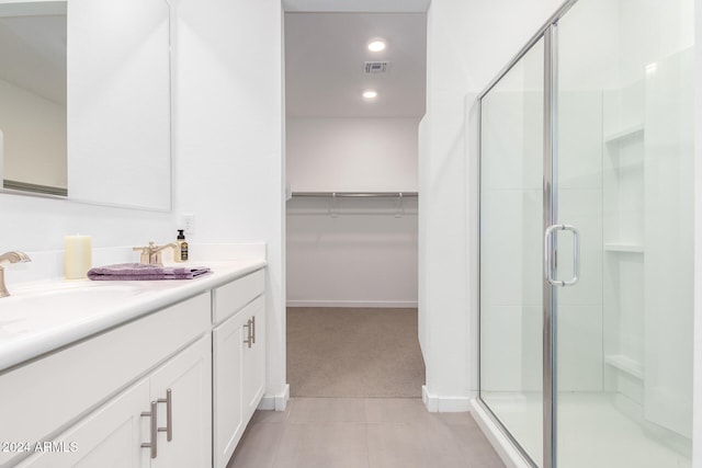 bathroom with vanity, tile patterned flooring, and a shower with door