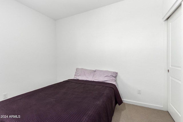 bedroom with light colored carpet