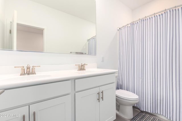 bathroom featuring toilet, a shower with curtain, and vanity