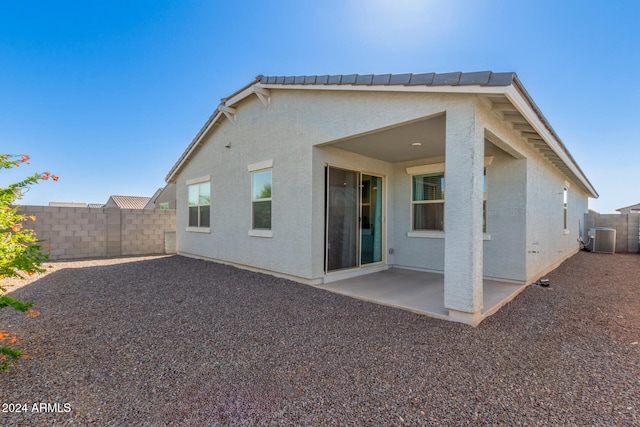 back of house featuring central air condition unit and a patio