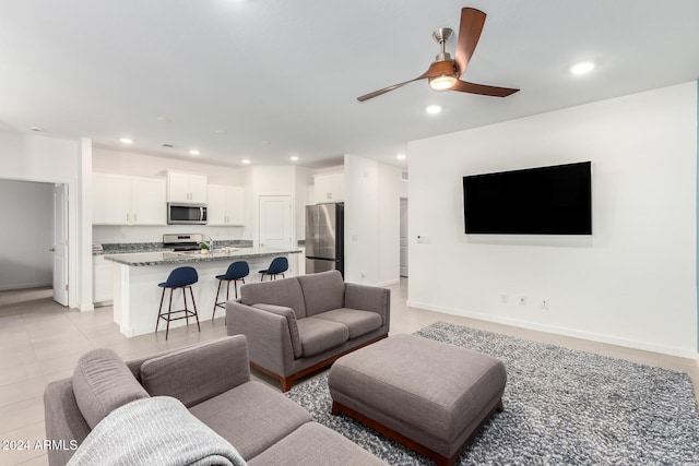 living room with light tile patterned floors and ceiling fan