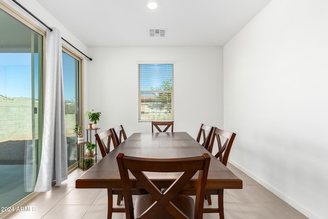 dining space with light tile patterned flooring and a wealth of natural light