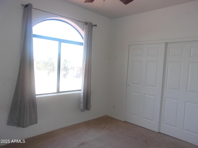 4616 E Monument Way, Rimrock, AZ 86335 - unfurnished bedroom featuring multiple windows, carpet floors, a closet, and ceiling fan