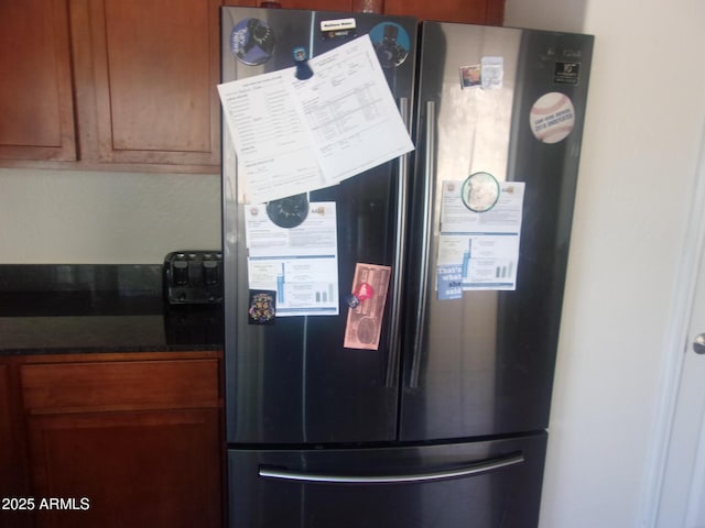 4616 E Monument Way, Rimrock, AZ 86335 - kitchen view of freestanding refrigerator, dark countertops, and brown cabinets