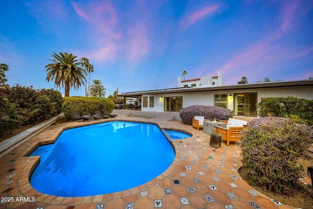 view of pool with a pool with connected hot tub and a patio area