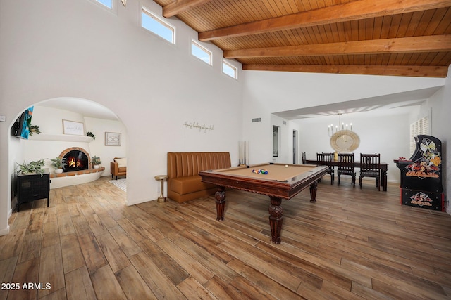 recreation room featuring beam ceiling, wood finished floors, pool table, high vaulted ceiling, and wood ceiling