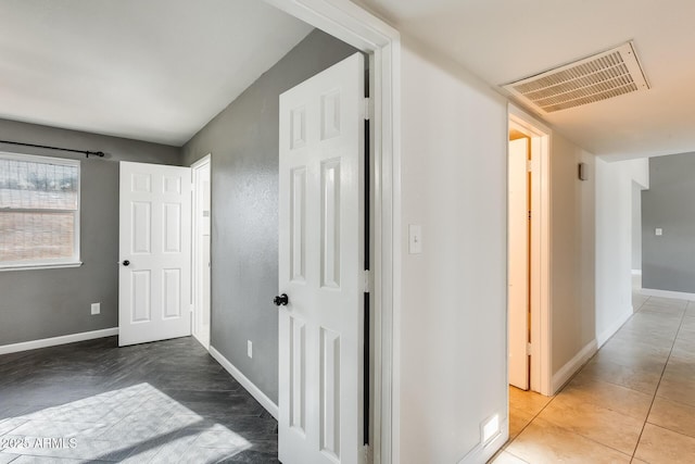 hallway with tile patterned floors