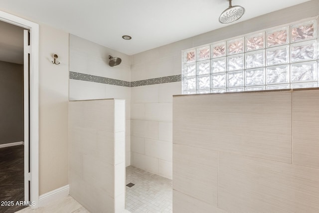 bathroom featuring tiled shower and tile patterned floors