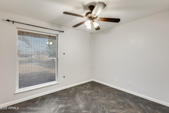 unfurnished room featuring dark parquet flooring and ceiling fan