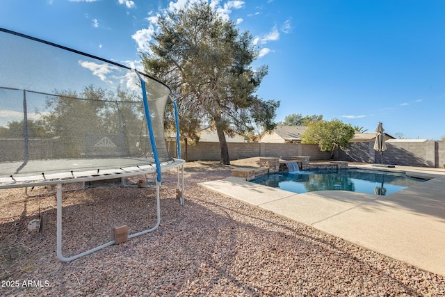 view of swimming pool with a trampoline