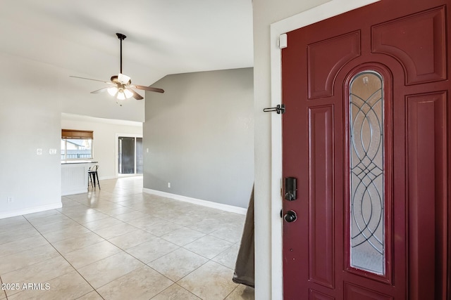 tiled entryway with ceiling fan and vaulted ceiling