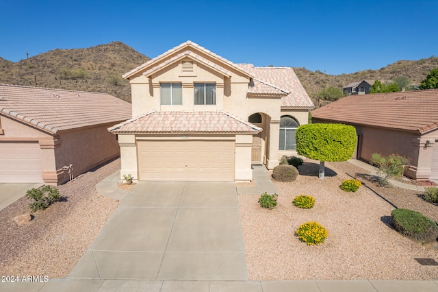 view of front of home featuring a garage and a mountain view