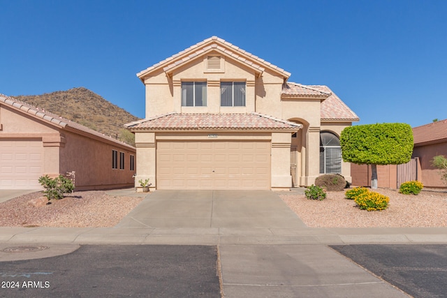 view of front of property featuring a mountain view and a garage