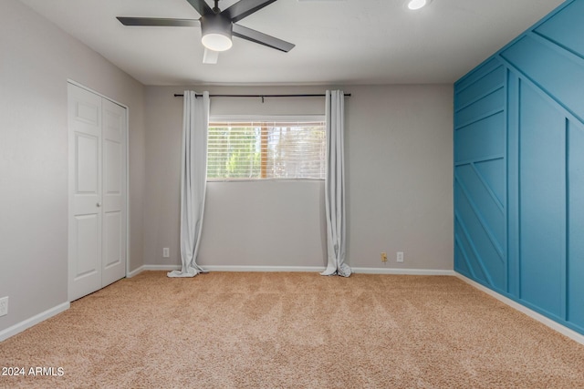 unfurnished bedroom with ceiling fan and light colored carpet