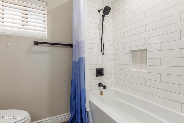 bathroom featuring shower / bath combo and toilet