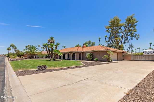 view of front of property with a garage and a front yard