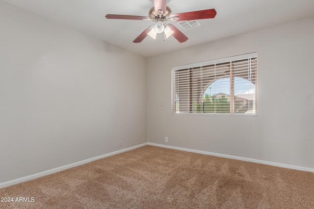 unfurnished room with carpet and ceiling fan