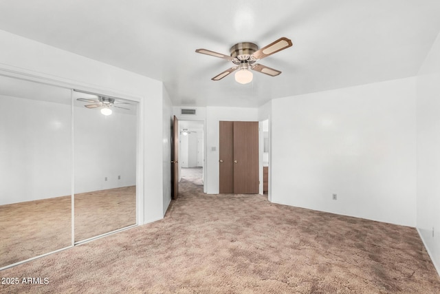 unfurnished bedroom with ceiling fan, carpet, and visible vents