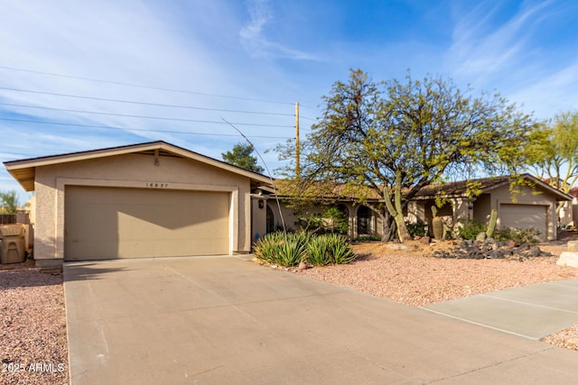 single story home with driveway, a garage, and stucco siding