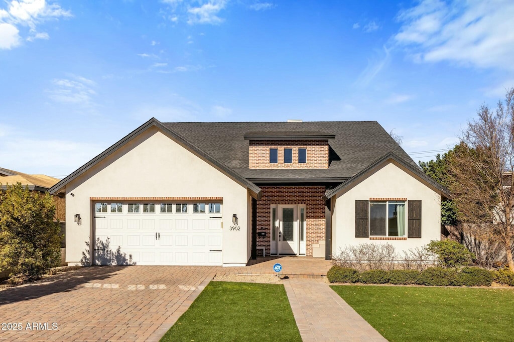 view of front facade with a front yard and a garage