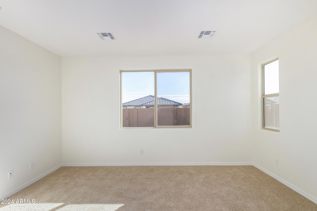 empty room with light colored carpet