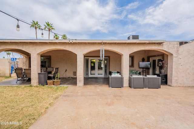 10601 N 36th St, Phoenix, AZ 85028 - back of property with french doors, a patio, an outdoor living space, and stucco siding
