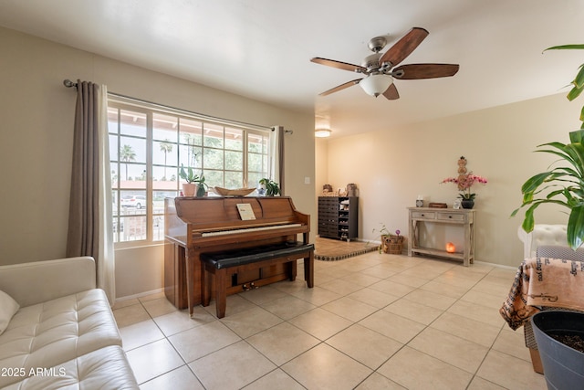 10601 N 36th St, Phoenix, AZ 85028 - sitting room with light tile patterned floors, ceiling fan, and baseboards