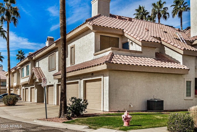 view of side of home with cooling unit and a garage