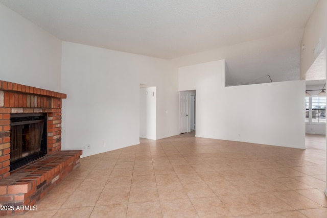 6534 S Marilyn Ann Dr, Tempe, AZ 85283 - unfurnished living room featuring a brick fireplace, light tile patterned floors, and high vaulted ceiling