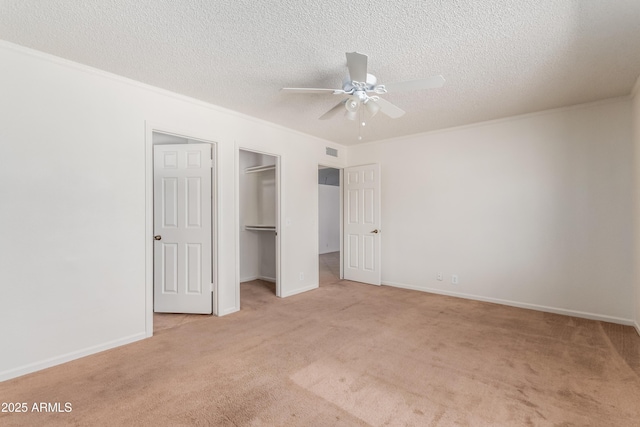 6534 S Marilyn Ann Dr, Tempe, AZ 85283 - unfurnished bedroom featuring visible vents, light carpet, ornamental molding, a textured ceiling, and a spacious closet