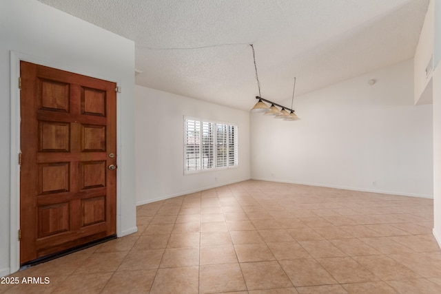 6534 S Marilyn Ann Dr, Tempe, AZ 85283 - unfurnished room with light tile patterned floors, baseboards, lofted ceiling, and a textured ceiling