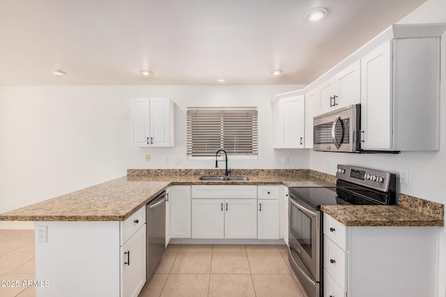 15440 S 38th St, Phoenix, AZ 85044 - kitchen featuring appliances with stainless steel finishes, a sink, a peninsula, white cabinets, and light tile patterned flooring