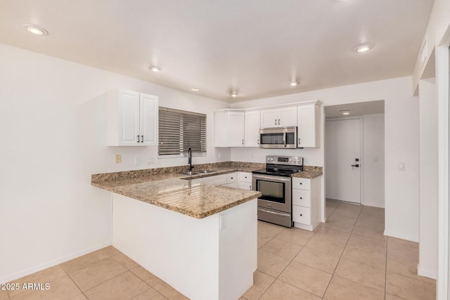 15440 S 38th St, Phoenix, AZ 85044 - kitchen with stainless steel appliances, a sink, a peninsula, white cabinetry, and recessed lighting