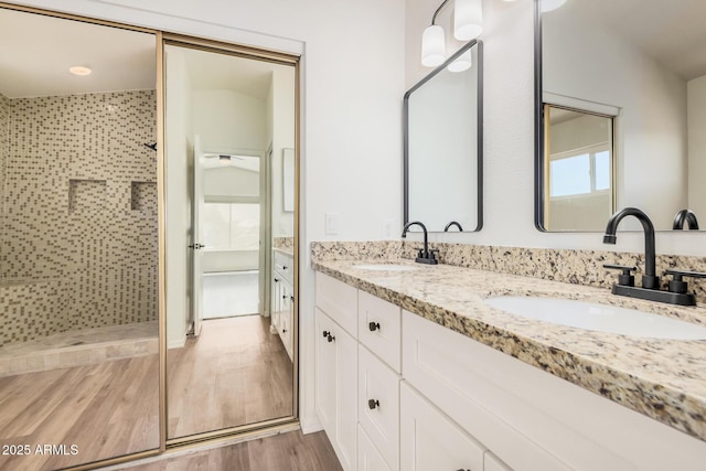 15440 S 38th St, Phoenix, AZ 85044 - bathroom with tiled shower, double vanity, and wood finished floors