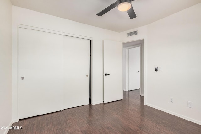 15440 S 38th St, Phoenix, AZ 85044 - unfurnished bedroom with dark wood-type flooring, a closet, baseboards, and a ceiling fan