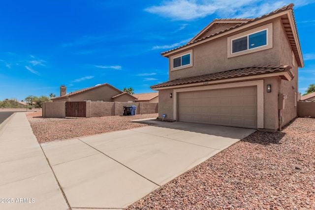 15440 S 38th St, Phoenix, AZ 85044 - view of side of home with stucco siding, an attached garage, a tiled roof, and driveway