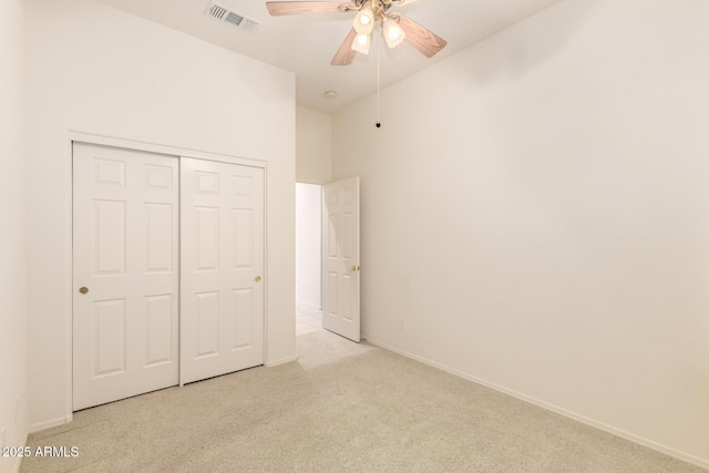 unfurnished bedroom with baseboards, visible vents, ceiling fan, a closet, and carpet flooring