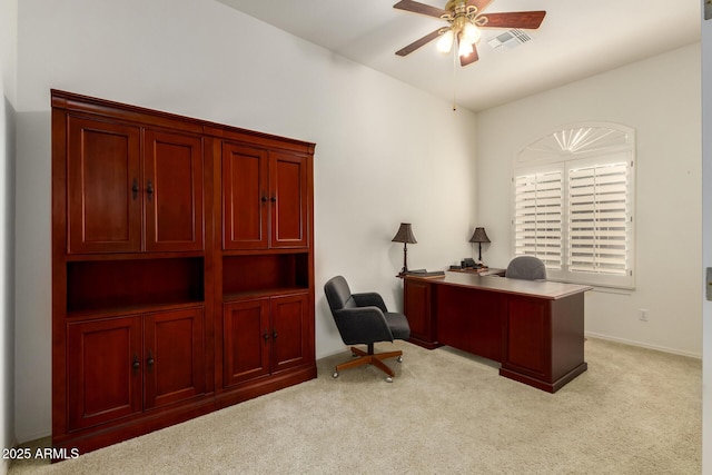 home office featuring a ceiling fan, visible vents, and light carpet