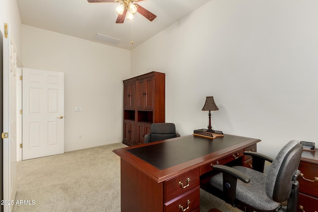 carpeted office space featuring ceiling fan