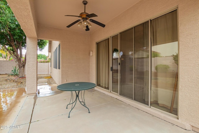 view of patio featuring a ceiling fan and fence