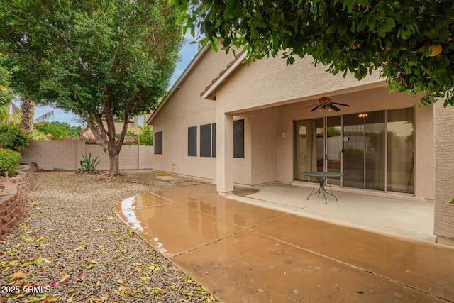 back of house featuring stucco siding, ceiling fan, a patio, and fence