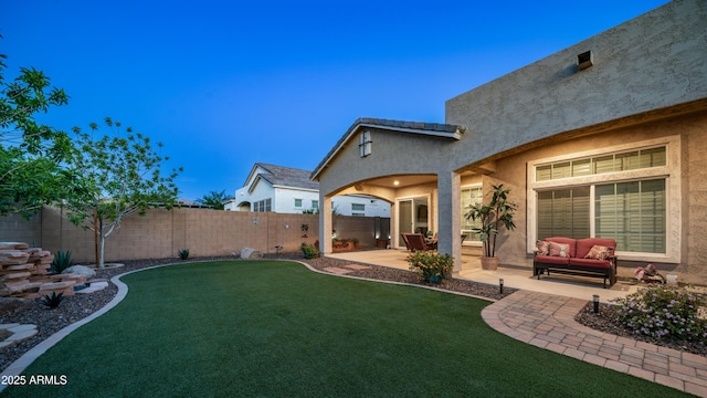 view of yard featuring a patio area, a fenced backyard, and an outdoor hangout area