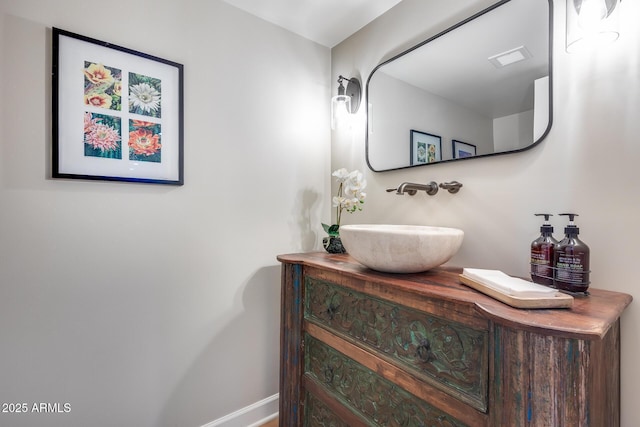 bathroom featuring baseboards and vanity