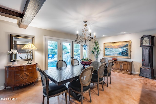 dining space with baseboards and a chandelier