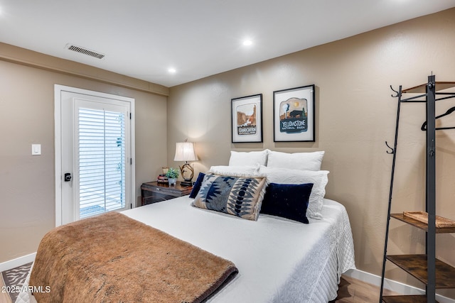 bedroom with baseboards, recessed lighting, and wood finished floors