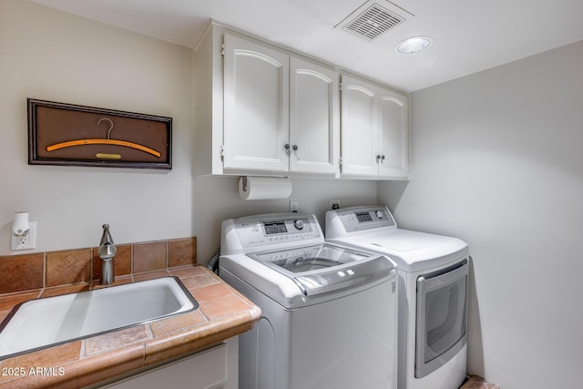 laundry area with cabinet space and independent washer and dryer